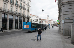 ep una persona con mascarilla anda por la calle calle alcala junto a la turistica puerta del sol