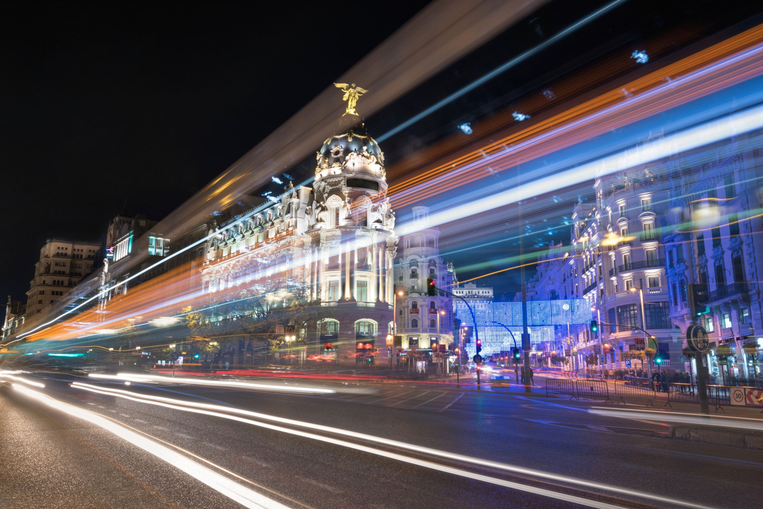 night photography madrid cityscape gran via street with rays traffic light madrid spain 