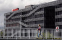 ep archivo   una persona camina al lado de la sede de vodafone en madrid