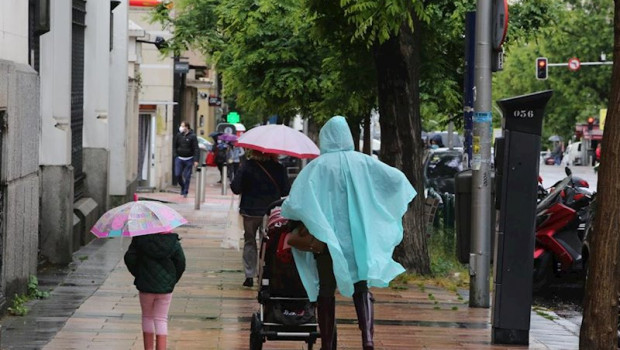 ep una mujer y una nina pasean con paraguas en la capital en un dia de lluvia y bajada de