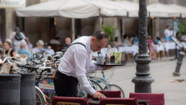 ep archivo   un camarero limpia una mesa en la plaza real de barcelona espana