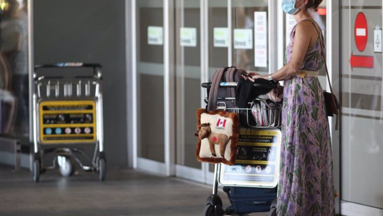 ep archivo   una mujer protegida con mascarilla llega con su equipaje a la terminal t1 del