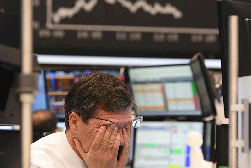 https://img2.s3wfg.com/web/img/images_uploaded/c/d/ep_main_a_stock_trader_rubs_his_eyes_on_the_floor_of_the_frankfurt_stock_exchange_stock_exchanges.jpg