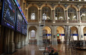 ep varias escaleras frente a dos paneles del ibex 35 en el palacio de la bolsa en madrid espana