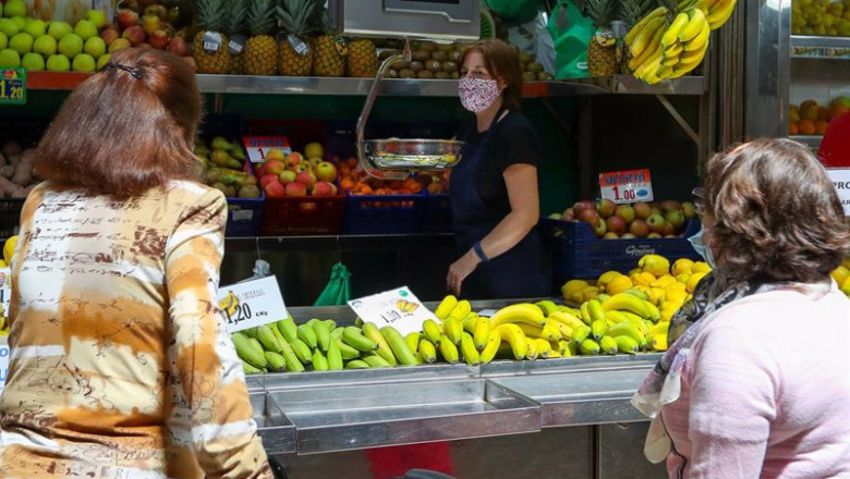 ep una trabajadora de una fruteria del mercado central de valencia atiende a dos clientas ep una trabajadora de una fruteria del mercado central de valencia atiende a dos clientas